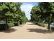 Scenic walking path lined with mature trees and manicured landscaping at 2708 Syracuse St # 109, Denver, CO 80238
