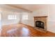 Bright, finished basement with hardwood floors and a cozy brick fireplace at 9182 Weeping Willow Ct, Highlands Ranch, CO 80130