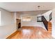 Finished basement with brick fireplace, hardwood floors and staircase at 9182 Weeping Willow Ct, Highlands Ranch, CO 80130