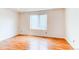 Bedroom with a large window and wood look floors at 9182 Weeping Willow Ct, Highlands Ranch, CO 80130