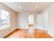 Bright bedroom featuring hardwood floors, large windows, and neutral paint at 9182 Weeping Willow Ct, Highlands Ranch, CO 80130