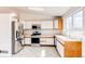 Bright kitchen with stainless steel appliances, white cabinets and light tile floors at 9182 Weeping Willow Ct, Highlands Ranch, CO 80130