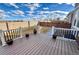 A view of the backyard deck with decorative railing and stone paver steps down to the yard at 12164 Poplar St, Thornton, CO 80602