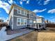 Exterior of home with gray siding, lots of windows, and a deck overlooking the backyard at 12164 Poplar St, Thornton, CO 80602