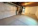 Unfinished basement showcasing cement floors, exposed ceiling, and white-wrapped walls at 12164 Poplar St, Thornton, CO 80602