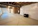 Unfinished basement showcasing cement floors, exposed ceiling, and white-wrapped walls at 12164 Poplar St, Thornton, CO 80602