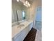 Bathroom with double sinks, white cabinets, and a large mirror at 12164 Poplar St, Thornton, CO 80602