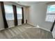 Neutral bedroom featuring lots of sunlight and a window with neutral curtains at 12164 Poplar St, Thornton, CO 80602