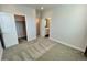 Neutral bedroom with doors to a bathroom and a walk-in closet at 12164 Poplar St, Thornton, CO 80602