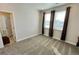 Neutral bedroom with carpet, windows, and modern curtains at 12164 Poplar St, Thornton, CO 80602