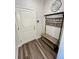 Entryway with coat rack, bench, mirror, and wood-look tile floors at 12164 Poplar St, Thornton, CO 80602