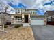 Charming two-story home featuring a two-car garage and a beautifully maintained front yard at 12164 Poplar St, Thornton, CO 80602