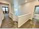 Bright, carpeted upstairs hallway leading to bedrooms and bathroom at 12164 Poplar St, Thornton, CO 80602