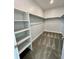 Spacious walk-in closet with ample shelving for optimal organization and storage at 12164 Poplar St, Thornton, CO 80602