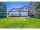 Expansive backyard with lush green lawn and well-maintained landscaping at 44 Spyglass Dr, Littleton, CO 80123