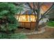 Backyard wooden deck with inviting lighting and landscaped surroundings at 44 Spyglass Dr, Littleton, CO 80123