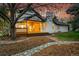 Tranquil backyard featuring a wooden deck, stone pathway, and charming landscaping at 44 Spyglass Dr, Littleton, CO 80123