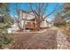 Landscaped backyard with flagstone path and mature trees at 44 Spyglass Dr, Littleton, CO 80123