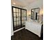 Modern bathroom with a large walk-in shower, hexagon tile flooring and white vanity at 44 Spyglass Dr, Littleton, CO 80123