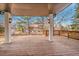 Covered deck overlooking a backyard with mature trees at 44 Spyglass Dr, Littleton, CO 80123