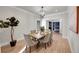 Bright dining room with hardwood floors, a chandelier, and seating for six at 44 Spyglass Dr, Littleton, CO 80123