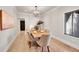 Formal dining room with light hardwood floors and a modern chandelier at 44 Spyglass Dr, Littleton, CO 80123