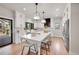 Modern kitchen with white cabinets, quartz countertops, and stainless steel appliances at 44 Spyglass Dr, Littleton, CO 80123