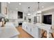 Modern kitchen with white cabinets, quartz countertops, and stainless steel appliances at 44 Spyglass Dr, Littleton, CO 80123