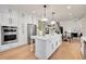 Modern kitchen with white cabinets, quartz countertops, and stainless steel appliances at 44 Spyglass Dr, Littleton, CO 80123