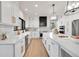 Modern kitchen with white cabinets, quartz countertops, and stainless steel appliances at 44 Spyglass Dr, Littleton, CO 80123