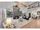 Open-concept living room features hardwood floors, a fireplace, and lots of natural light at 44 Spyglass Dr, Littleton, CO 80123