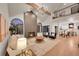 Open-concept living room features hardwood floors, a fireplace, and lots of natural light at 44 Spyglass Dr, Littleton, CO 80123
