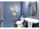 Elegant powder room with a modern pedestal sink and hexagon tile floor at 44 Spyglass Dr, Littleton, CO 80123