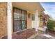 Inviting front entrance with a secure storm door, brick facade, and covered porch area at 3242 S Oneida Way, Denver, CO 80224