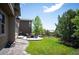 Lush backyard featuring a well-maintained lawn, patio, and mature trees at 350 Andromeda Ln, Castle Rock, CO 80108
