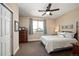 Bedroom with carpet, ceiling fan, and a window with blue curtains at 350 Andromeda Ln, Castle Rock, CO 80108