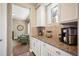 Charming butler's pantry with granite countertops, white cabinets, and a coffee bar area at 350 Andromeda Ln, Castle Rock, CO 80108