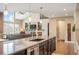 Spacious kitchen island with granite countertops and seamless flow into the living area at 350 Andromeda Ln, Castle Rock, CO 80108