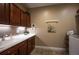Laundry room with dark wood cabinets, modern lighting and sink at 350 Andromeda Ln, Castle Rock, CO 80108