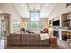 Bright living room featuring vaulted ceilings, large windows, a fireplace, and comfortable seating arrangements at 350 Andromeda Ln, Castle Rock, CO 80108