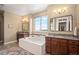 Bright main bathroom with tile floors, soaking tub, and double sink vanity at 350 Andromeda Ln, Castle Rock, CO 80108