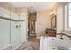 Bright main bathroom with tile floors, soaking tub, and glass enclosed shower at 350 Andromeda Ln, Castle Rock, CO 80108