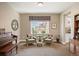 Cozy sitting room featuring comfortable seating, natural light, and a charming decor with a piano at 350 Andromeda Ln, Castle Rock, CO 80108