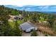 Aerial view of home and barn on expansive property with scenic mountain views at 8537 S Doubleheader Hwy, Morrison, CO 80465