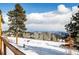 Picturesque backyard with snow-covered fields, mature trees, and stunning mountain views at 8537 S Doubleheader Hwy, Morrison, CO 80465