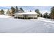 Barn on snow-covered lot with fenced enclosure and wood pile at 8537 S Doubleheader Hwy, Morrison, CO 80465