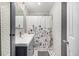 Bathroom with white subway tile, updated vanity and decorative floral shower curtain at 8537 S Doubleheader Hwy, Morrison, CO 80465