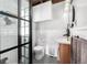 Modern bathroom with a glass shower, subway tile, and black-and-white flooring at 8537 S Doubleheader Hwy, Morrison, CO 80465