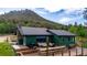 Exterior view of mountain home with a spacious deck and forest views at 8537 S Doubleheader Hwy, Morrison, CO 80465
