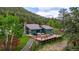 Charming home with a spacious wooden deck, outdoor seating, and a serene natural setting at 8537 S Doubleheader Hwy, Morrison, CO 80465